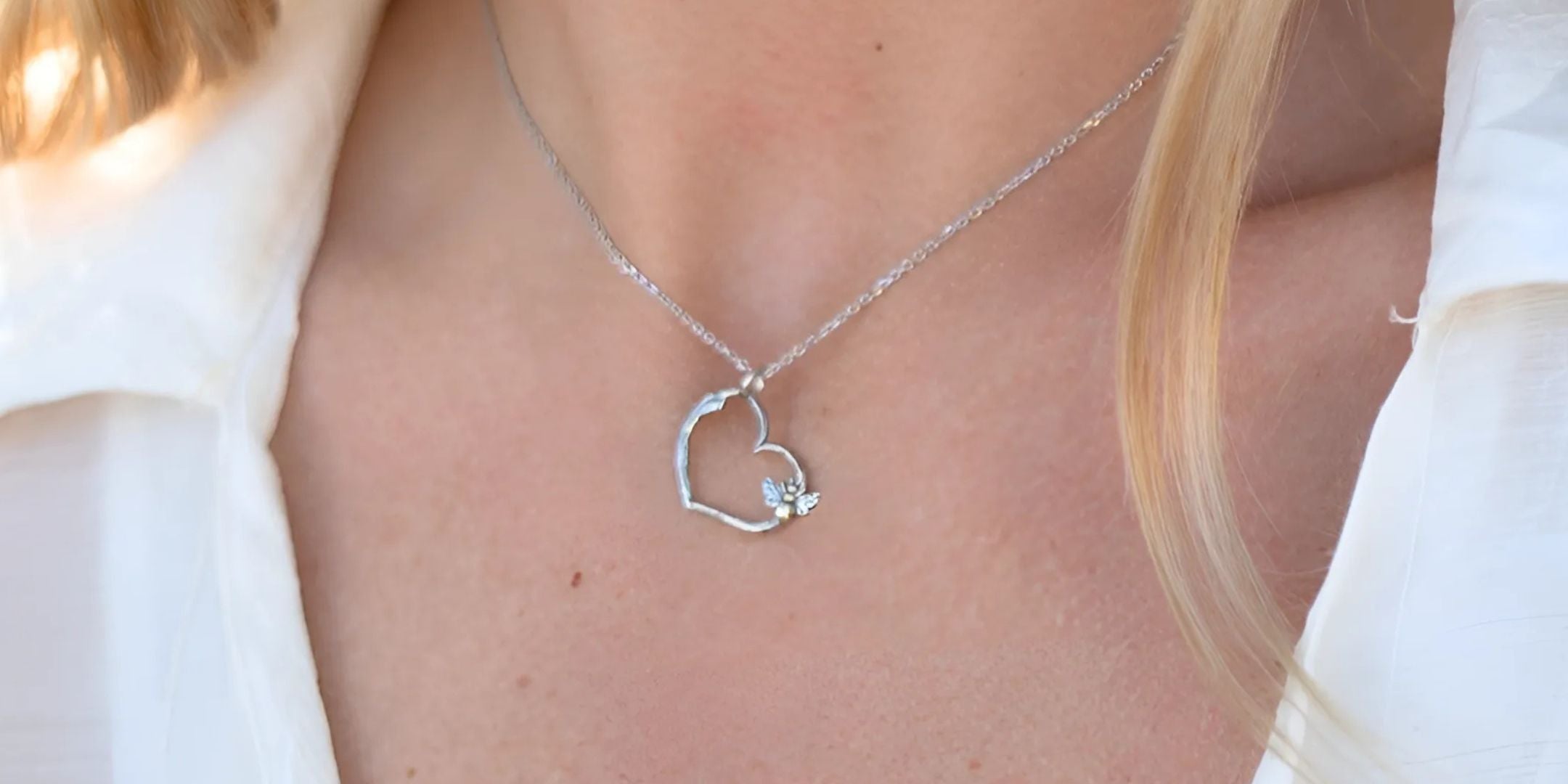 Close-up of the Willow Heart Necklace, a nature-inspired, hand-crafted sterling silver design featuring a delicate heart shape with floral and branch detailing.